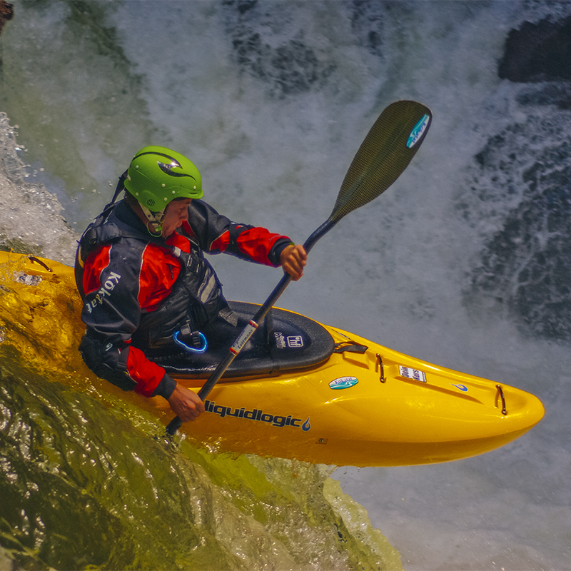 A man kayaks a waterfall on the White Salmon River