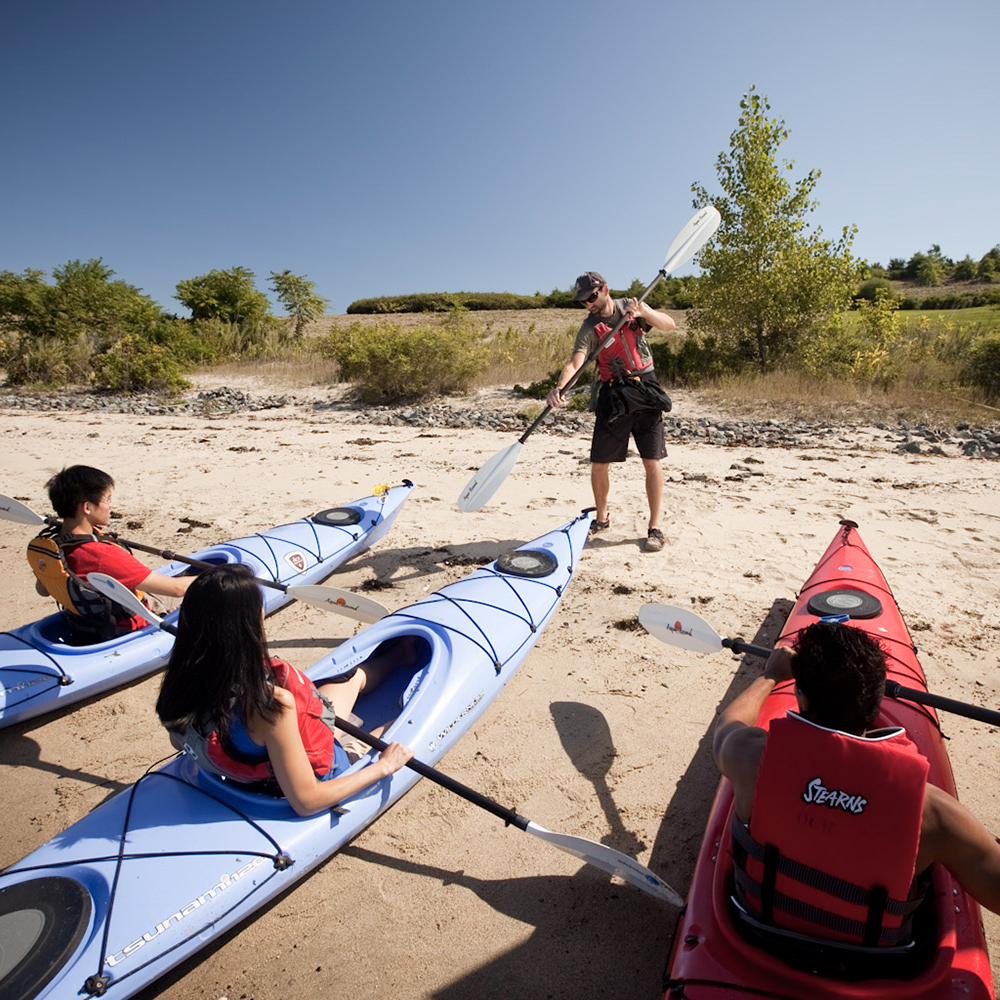 A guide teaches kayak tours