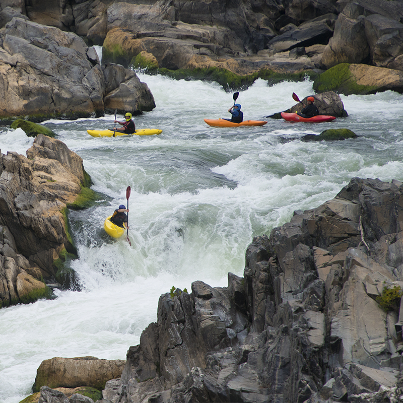 Kayakers kayaking waterfalls at Great Falls National Park, Virginia