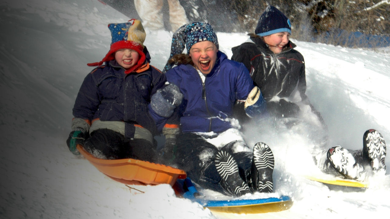 kids sledding down a hill
