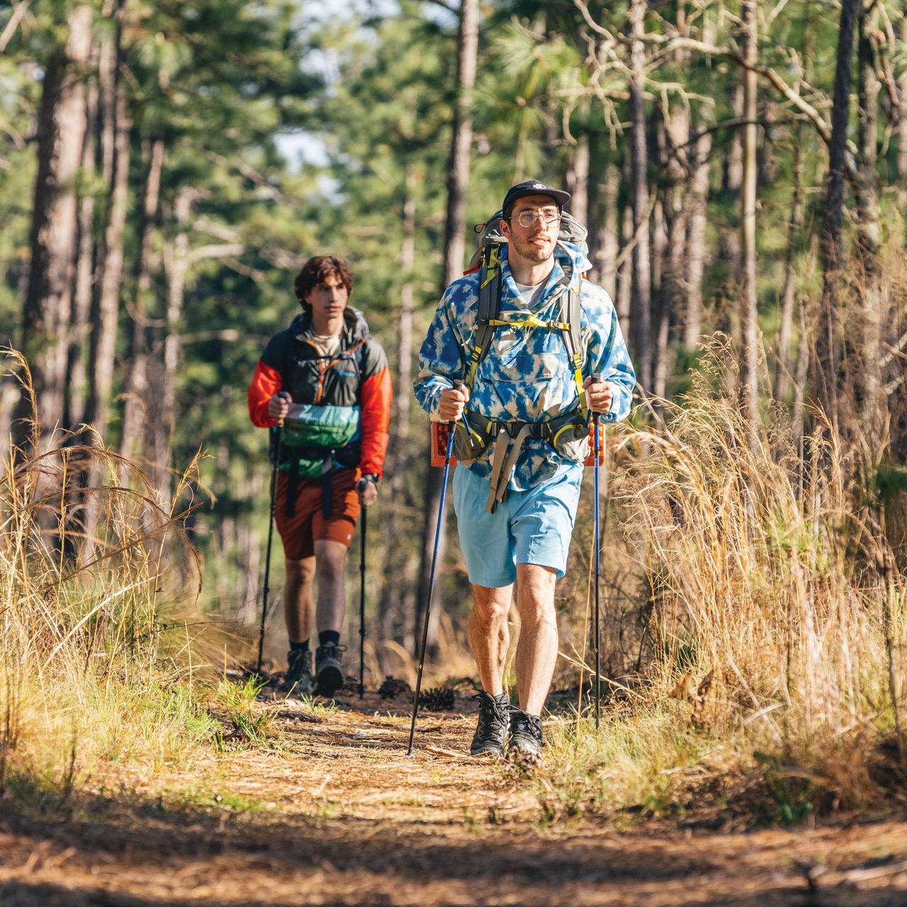 Two ultralight backpackers hike in the forest