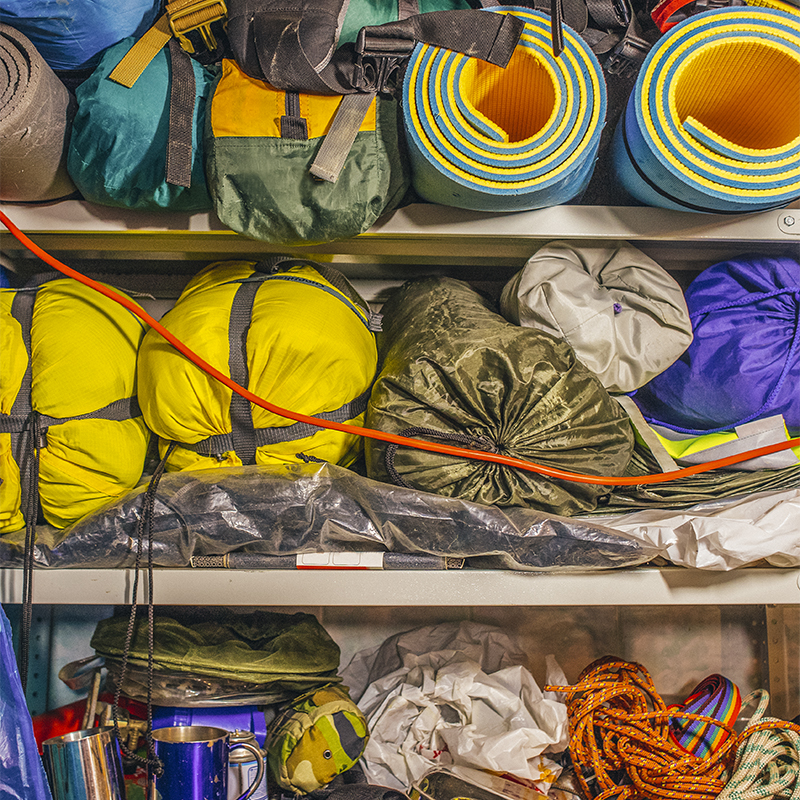 Outdoor adventure equipment stored in a garage