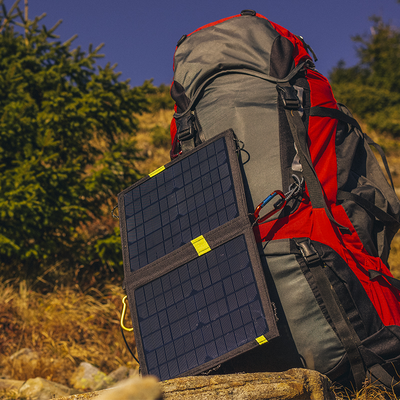 A portable solar panel attached to a backpack