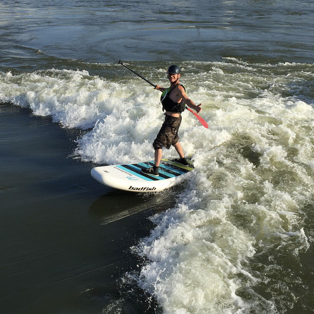 A SUP paddler at RiverScape and its whitewater feature, River Run