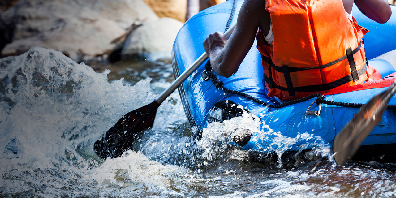 Close-up of young person rafting on the river