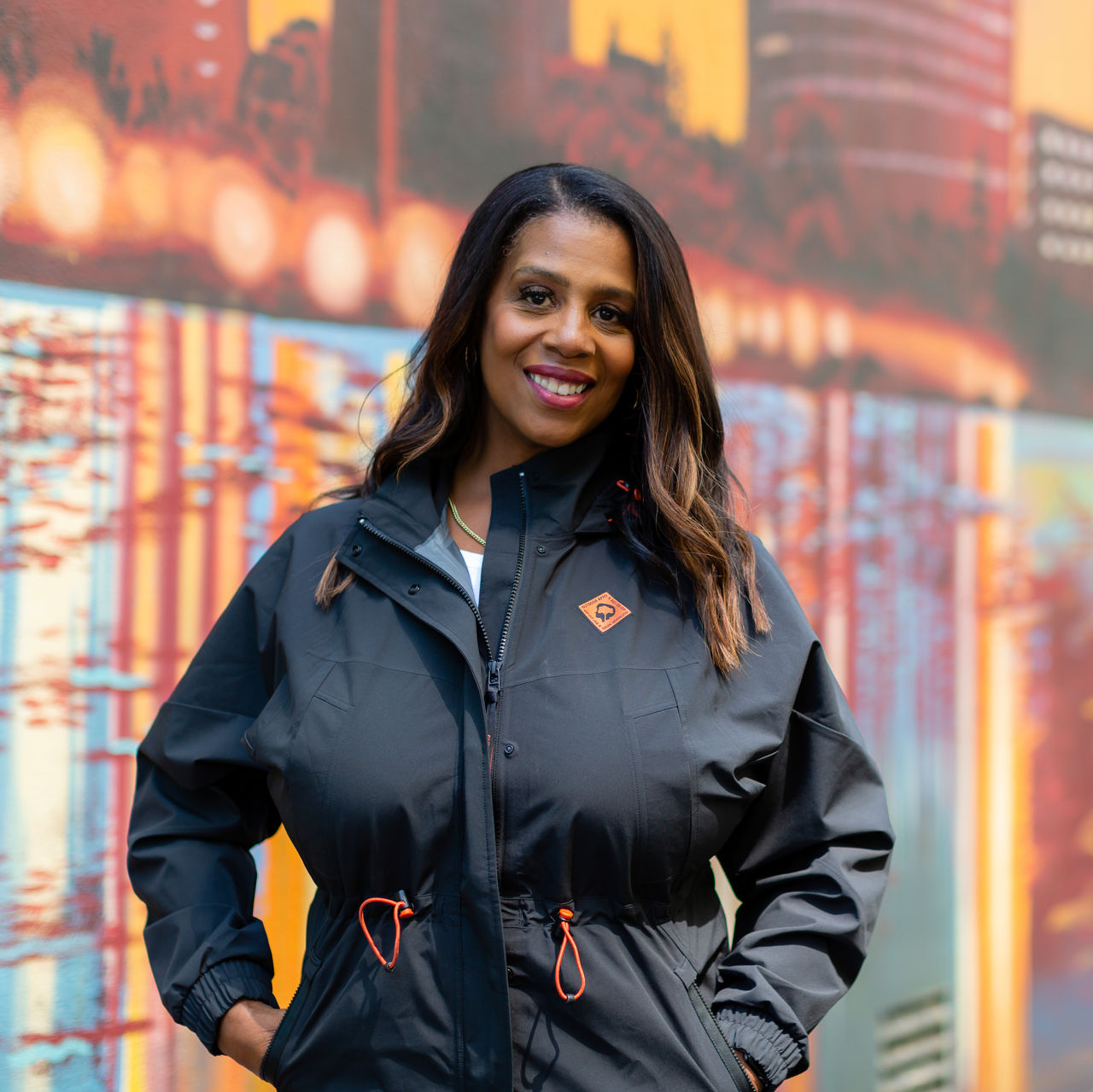 A photo of Rue Mapp standing with a surfboard